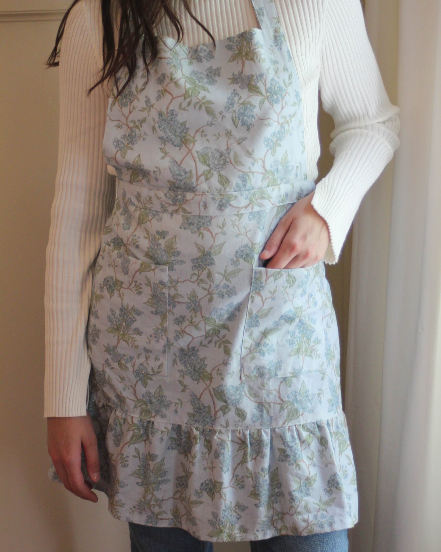 Floral apron in Hyacinth design, organic cotton fabric with ruffle hem detail, perfect for seasonal cooking, hosting, and gifting for Mother’s Day or spring occasions.