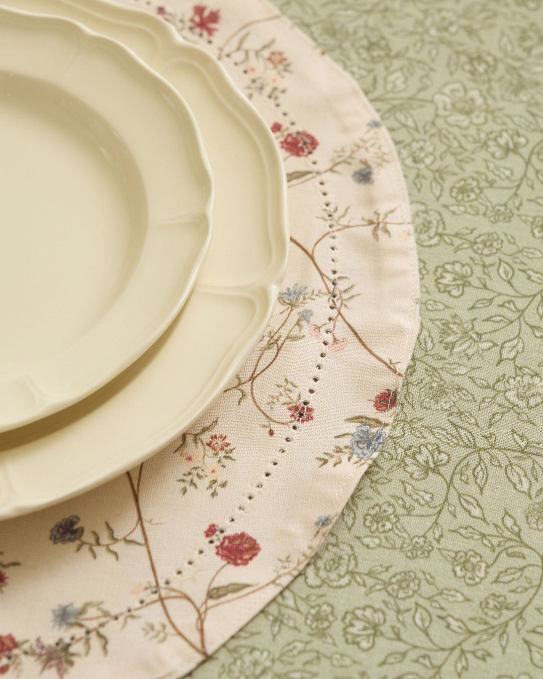Antique floral placemats with cream, moss green, terracotta, dusty blue, pale yellow, and soft pink botanical details.