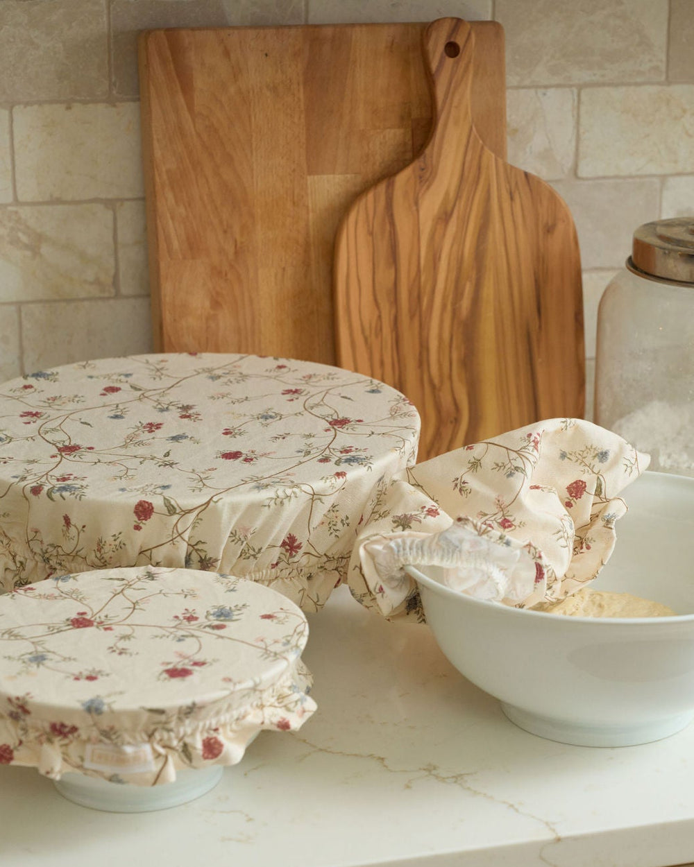 Antique-inspired floral cotton bowl covers in three reusable sizes with breathable fabric, secure elastic edges, and ruffle detailing, perfect for covering dough, storing food, preparing dishes ahead, everyday baking, holiday hosting, sourdough lovers, housewarming gifts, and plastic-free kitchens.