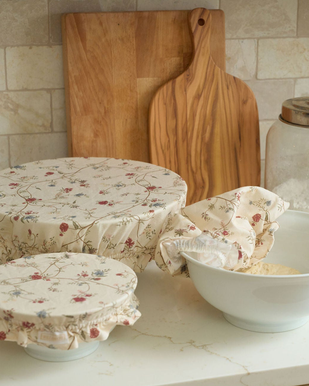 Antique-inspired floral cotton bowl covers in three reusable sizes with breathable fabric, secure elastic edges, and ruffle detailing, perfect for covering dough, storing food, preparing dishes ahead, everyday baking, holiday hosting, sourdough lovers, housewarming gifts, and plastic-free kitchens.