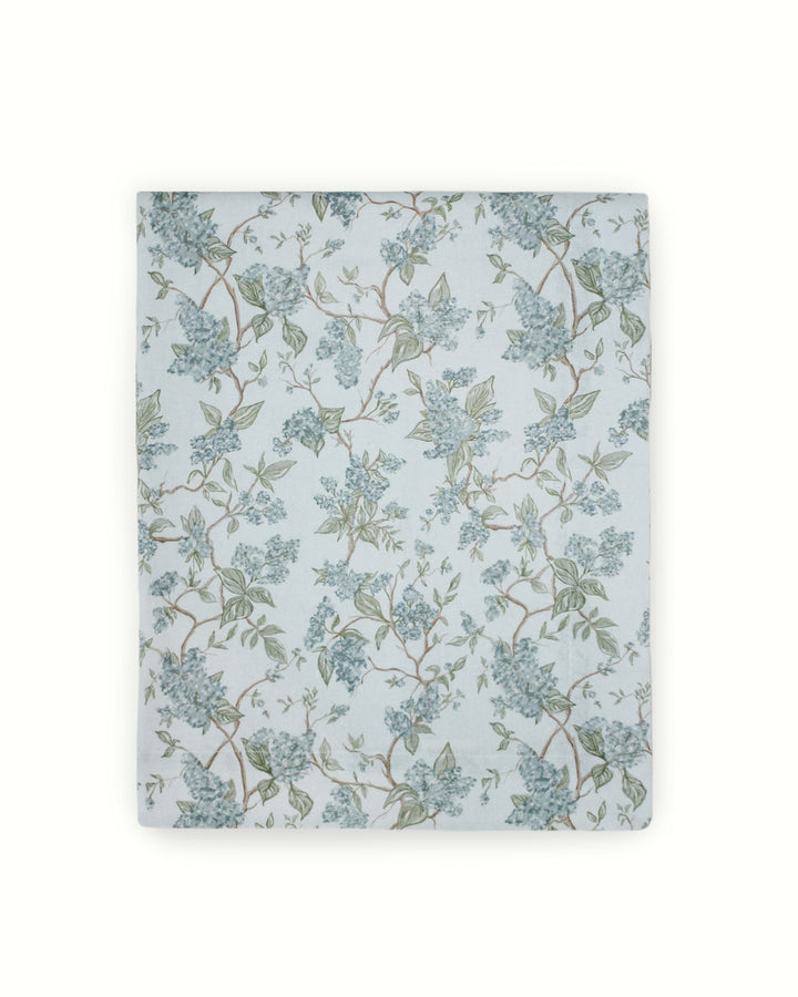 Charming floral tablecloth with a chinoiserie inspired blue and green botanical print, perfect for spring weddings, rehearsal dinners, and elegant Easter tablescapes. Crafted from premium cotton with non-toxic dyes, this cotton tablecloth suits French country, English garden, and grand millennial decor styles. Designed in Charleston and handmade in India, it adds timeless charm to wedding receptions and Mother’s Day brunch tables.