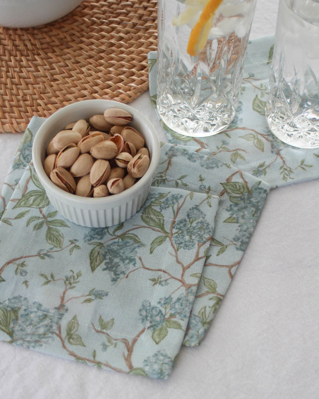 Blue floral cocktail napkins set of 4 in 100% cotton, perfect for summer drinks and serving as fabric coasters.