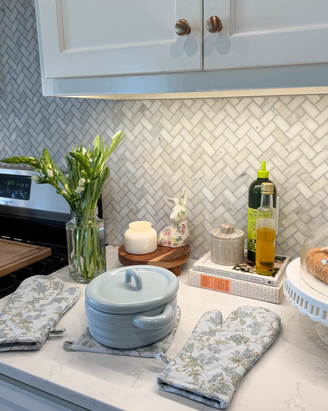 Blue floral quilted oven mitts and pot holders in elegant kitchen. Perfect kitchen accessories for a traditional, modern kitchen