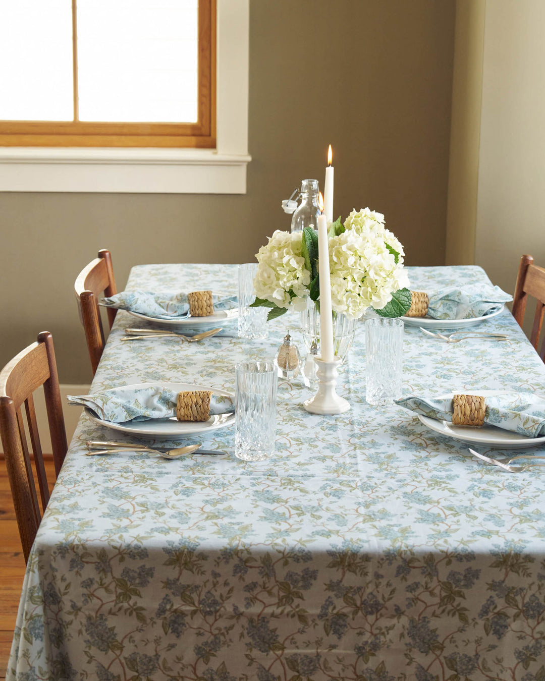 Spring tablescape styled with a blue hydrangea cotton tablecloth, perfect for gathering and hosting.