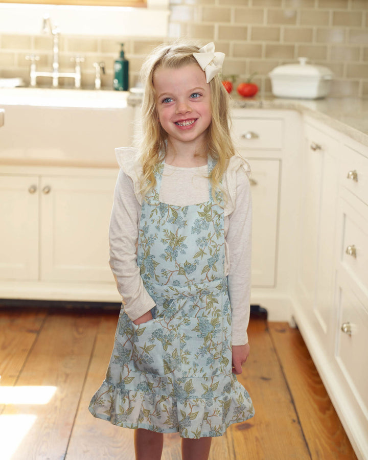 Kids cotton apron with a soft blue hydrangea watercolor design, perfect for baking and kitchen moments.