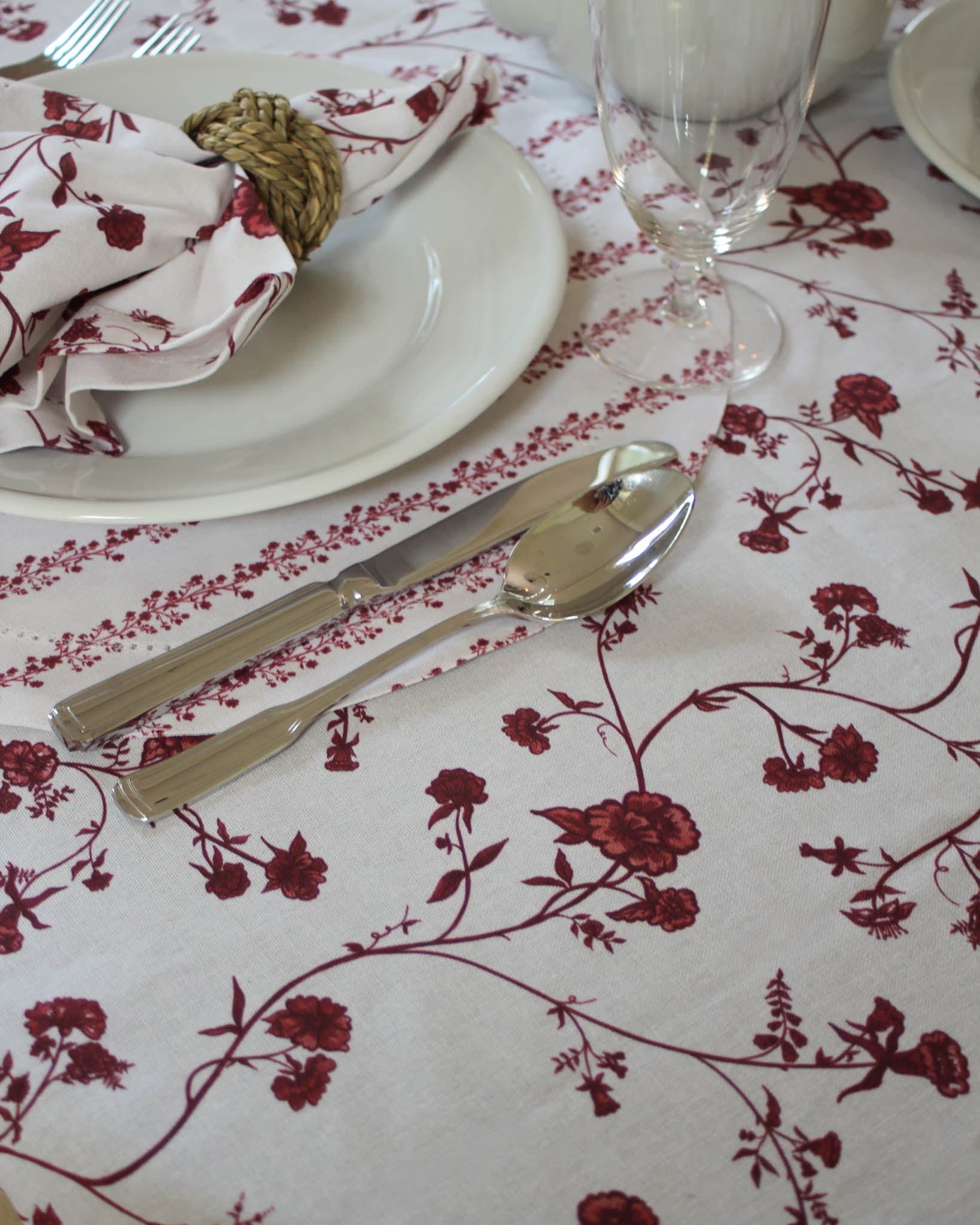 Close-up of Red Garden Vine tablecloth showing hand-drawn botanical print on soft organic cotton fabric ethically made in India