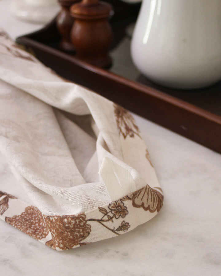 Brown floral kitchen towel with hanger loop, ideal for sourdough baking, food prep, and kitchen styling.