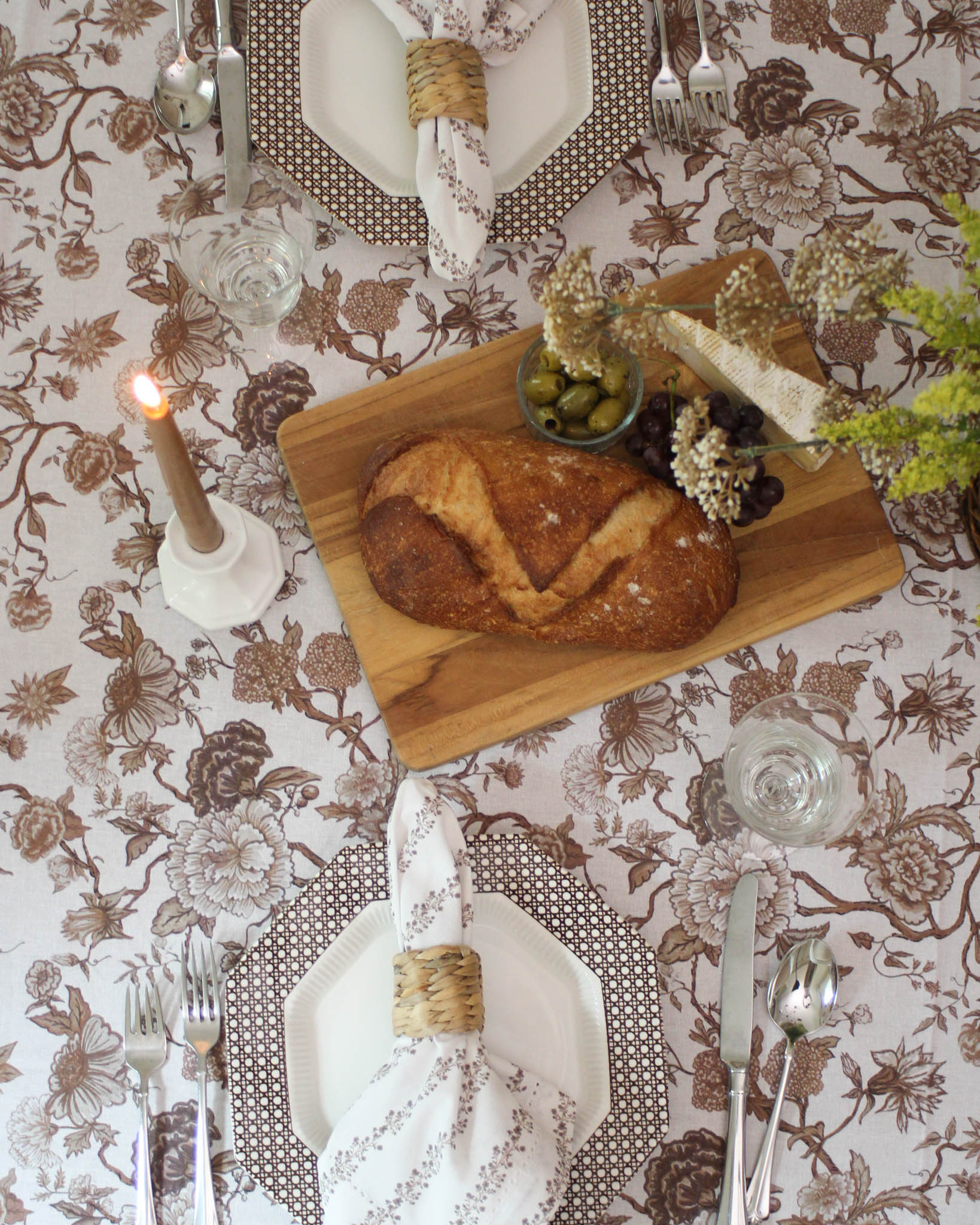 Chestnut brown organic cotton tablecloth with hand-drawn floral design styled for a cozy fall dinner