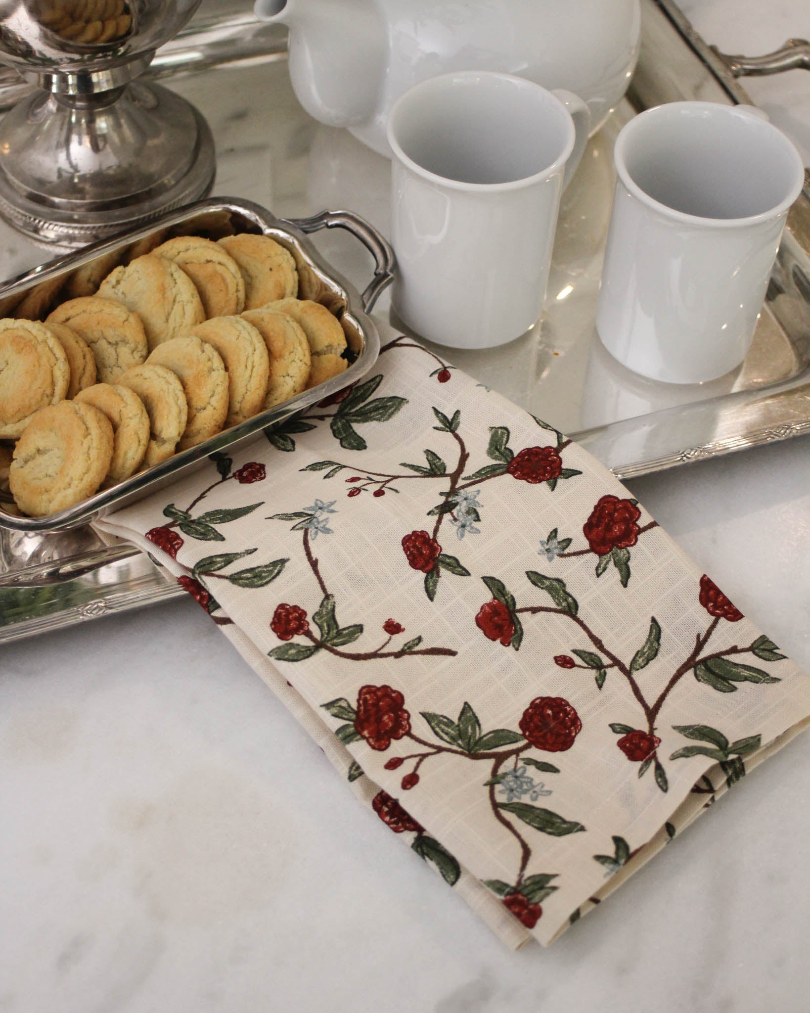 Hand-drawn red floral tea towel in organic cotton. Hanging loop, perfect for Christmas baking & entertaining. Thoughtful hostess gift, sustainably made.