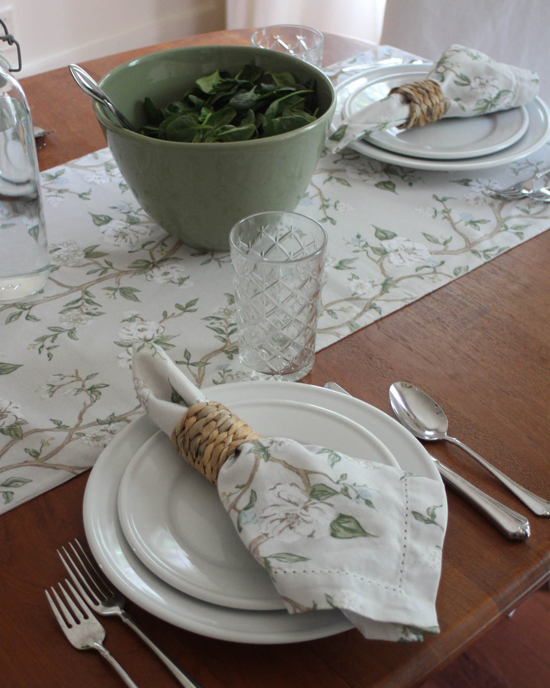Give your farmhouse table a spring refresh with this Chinoiserie-inspired botanical runner. The charming blue and green flowers and leaves are hand-drawn with love on a 100% cotton base. This runner provides a soft, elegant contrast to rustic wood furniture. Ideal for Easter table decor, Mother’s Day brunch, or daily summer meals. Durable and machine-washable, it’s designed for real-life hosting while maintaining a high-end, polished look for your guests.