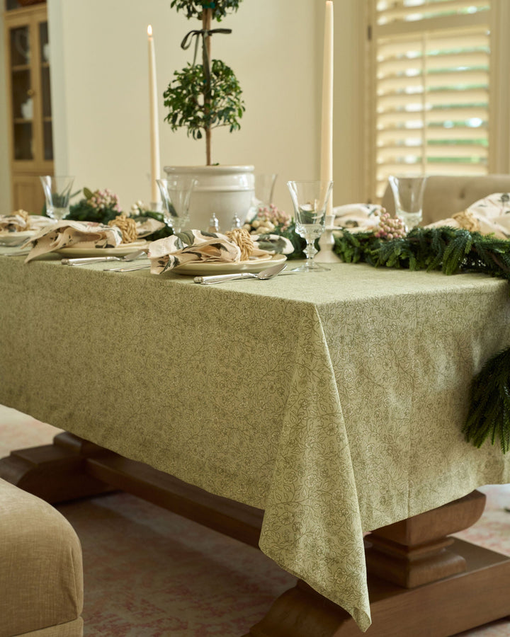 Elegant neutral floral cotton tablecloth styled for a classic Christmas table setting with timeless holiday decor.