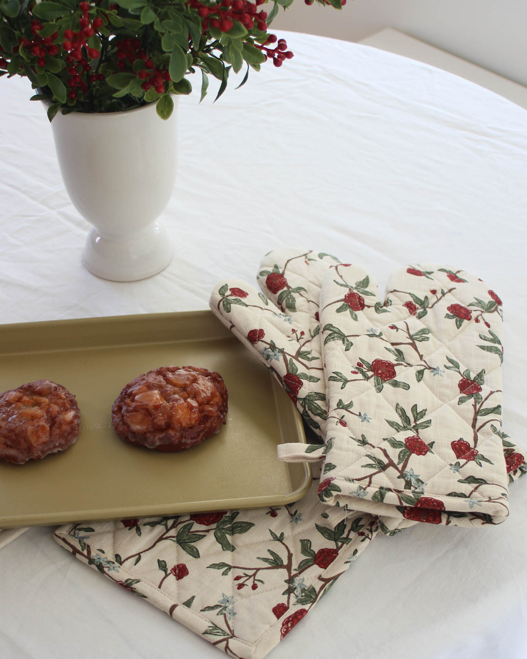 Essential cooking accessories for the home chef, these double oven mitts combine a sophisticated floral print with heavy-duty protection. The 7x13.5 inch size fits most hands comfortably, providing a secure grip on hot pots and baking sheets. The red and green botanical design is hand-drawn, offering a unique touch to your kitchen textile collection. Durable, washable, and heat-resistant, these mitts are a reliable partner for every recipe.