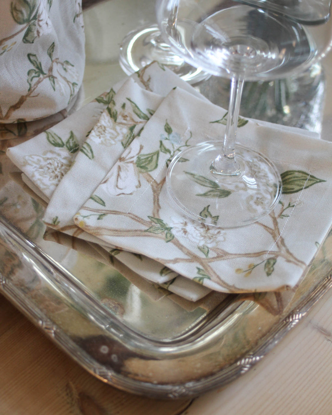 Cotton cocktail napkins with hand-drawn camellia print, styled for Southern living and Charleston-inspired decor.