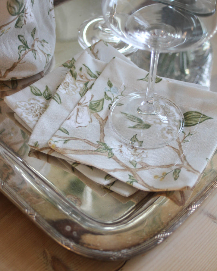 Cotton cocktail napkins with hand-drawn camellia print, styled for Southern living and Charleston-inspired decor.