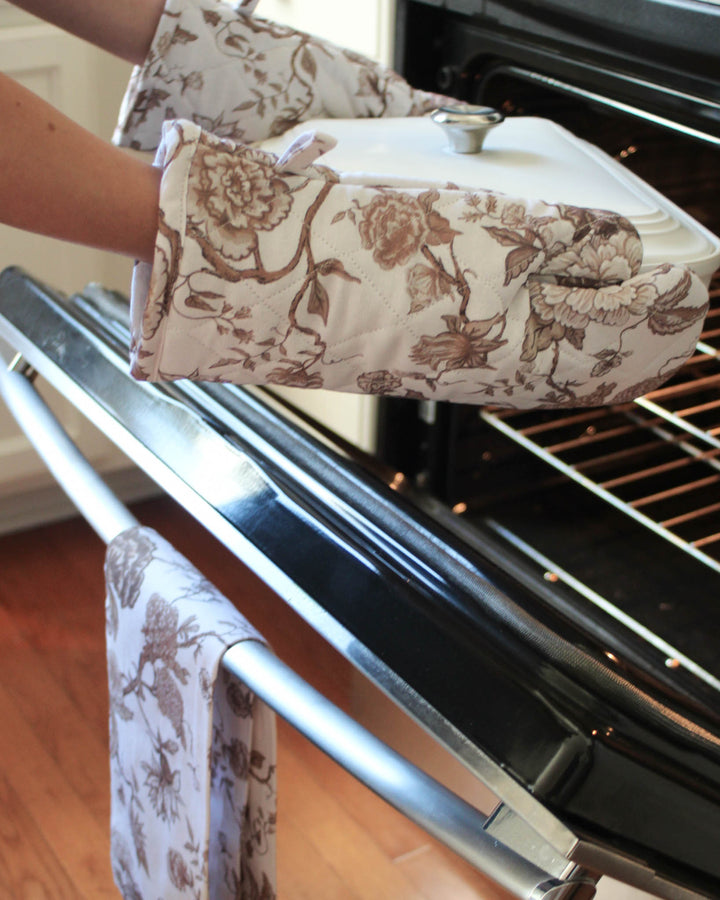 Cotton kitchen gloves with hand-drawn brown floral design, combining function and style for everyday kitchen use.