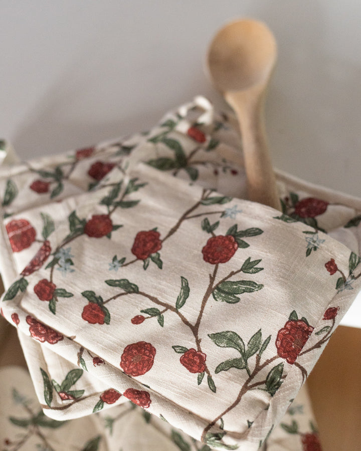 Charming red floral pot holders make a delightful gift for the home cook or baker. With their soft cream background and vibrant red flowers, they’re not only heat-resistant and durable but also add a touch of warmth and style to any kitchen.