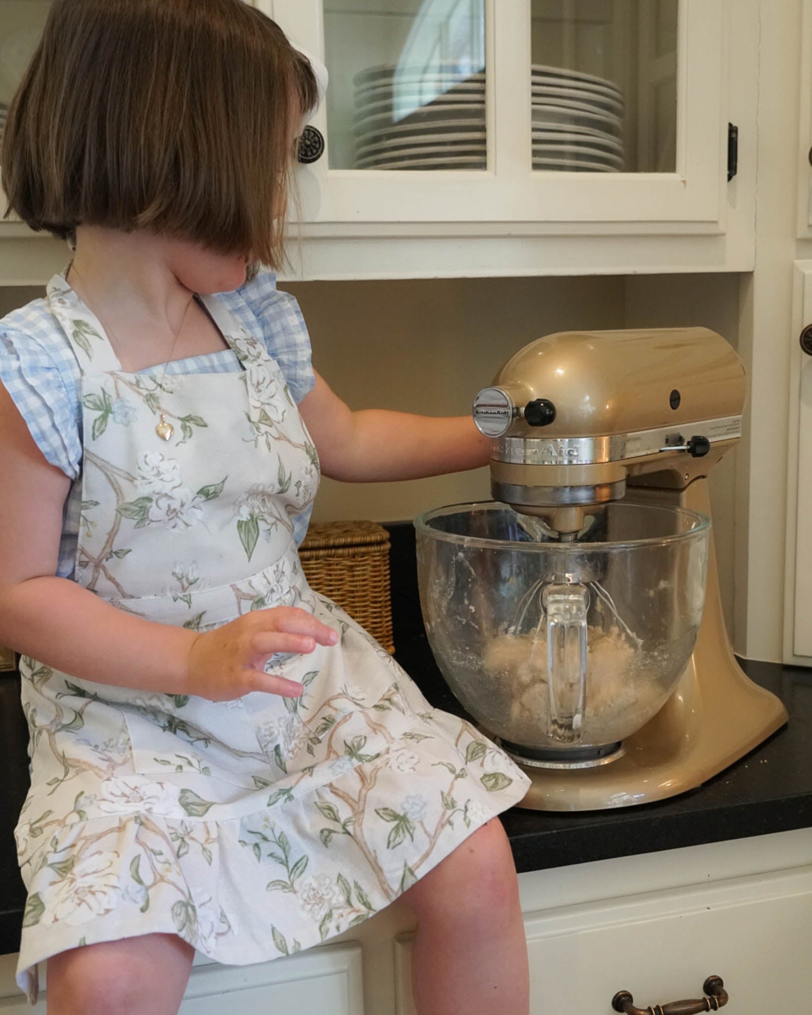 Little girl’s ruffle apron in our floral Camellia print, a sweet and thoughtful heirloom little girls birthday gift.