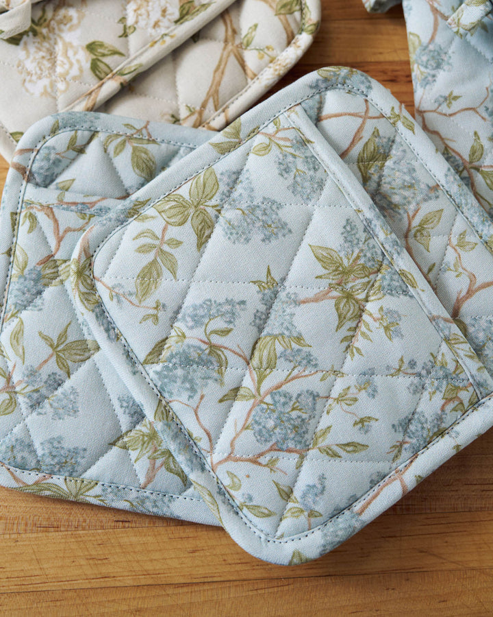 Easter hosting kitchen styled with blue hydrangea cotton pot holders.