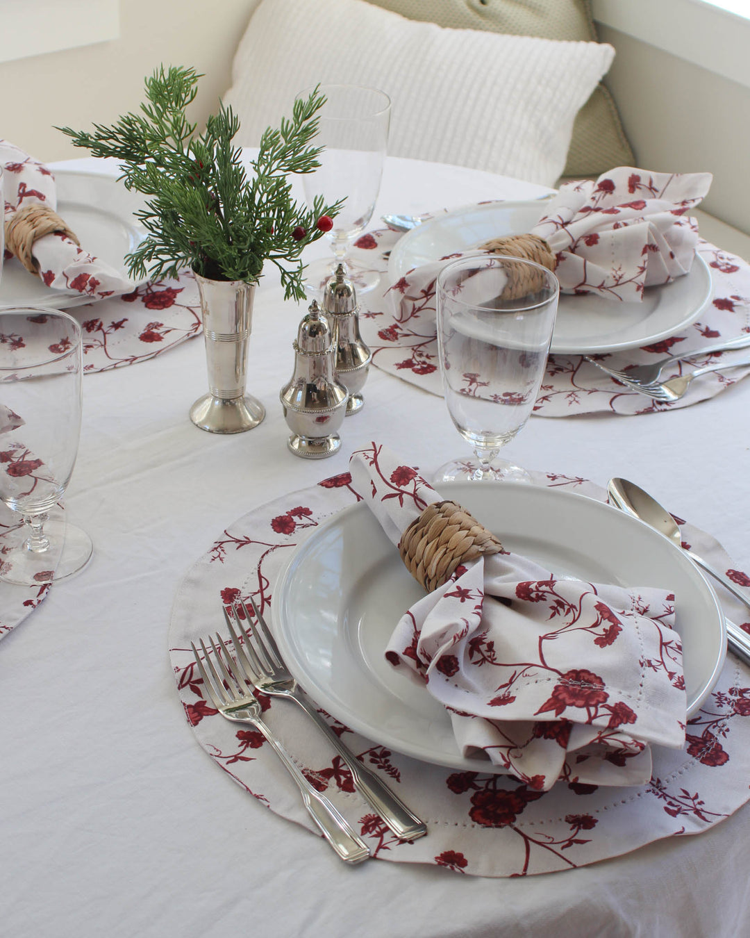 Elegant red floral napkins for holiday table settings made from 100% organic cotton with hemstitch detail.