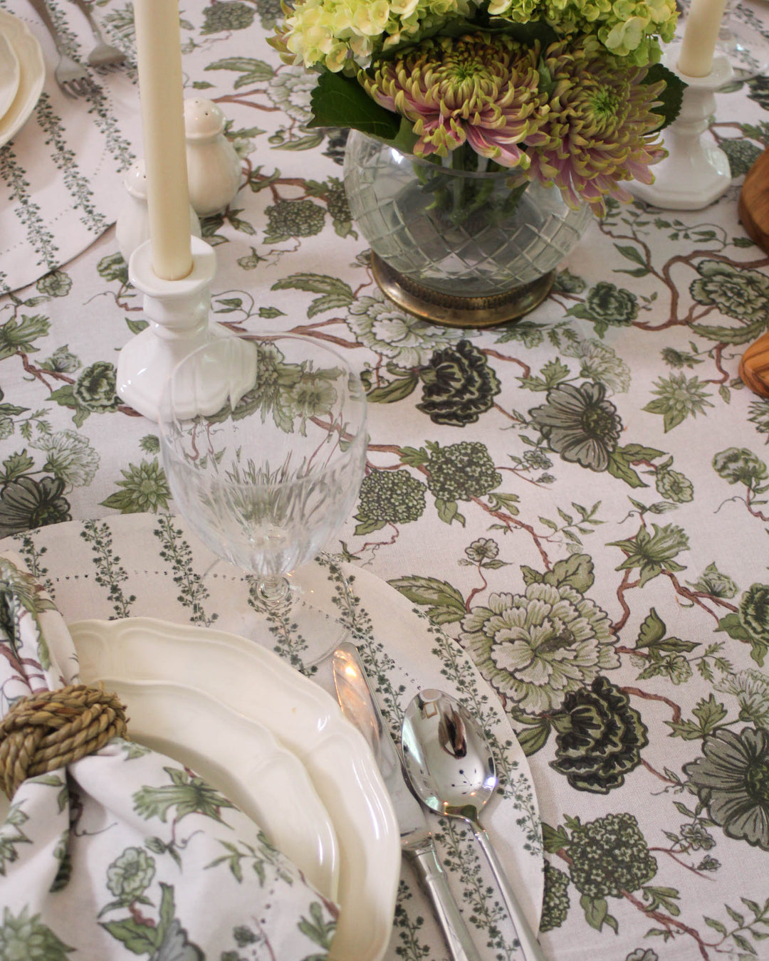 Spring Tablecloth in a classic William Morris Print style. This Rectangle Tablecloth comes in 66x104 and 66x120 sizes, featuring a lush Chinoiserie Print in green and white. Ideal as a Wedding Tablecloth or for a Rehearsal Dinner, providing a vintage botanical look. This Floral Tablecloth is handcrafted to ensure a premium feel on long dining tables. Elevate your hosting with this versatile Spring Table Cover that fits most large rectangular and Oval tablecloth settings.