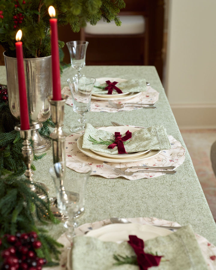 Hand-drawn floral placemats styled for a festive Christmas dining table with timeless holiday table linens.