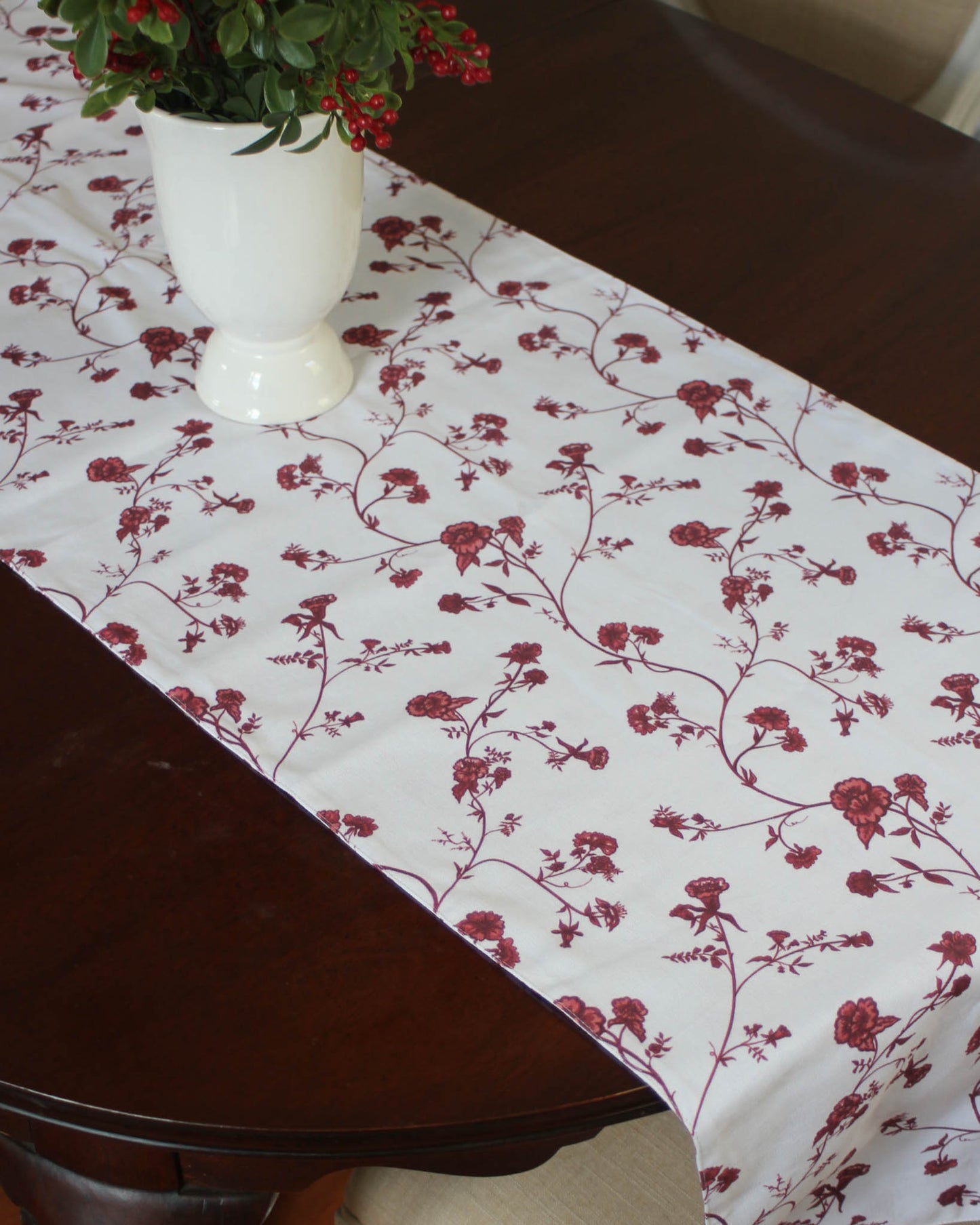 Table Runner with all over floral print in red. available in two sizes this runner is perfect for holiday hosting or gifting.