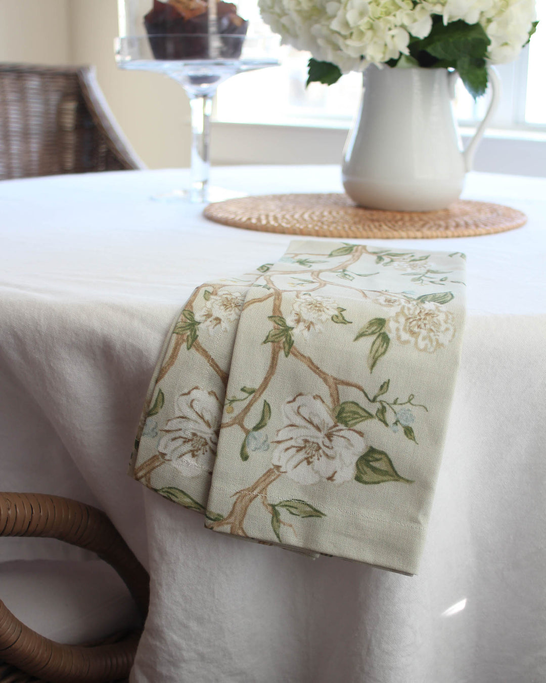 Floral cotton tea towel in Charleston-inspired camellia print, styled for Southern living kitchens and cozy spaces.