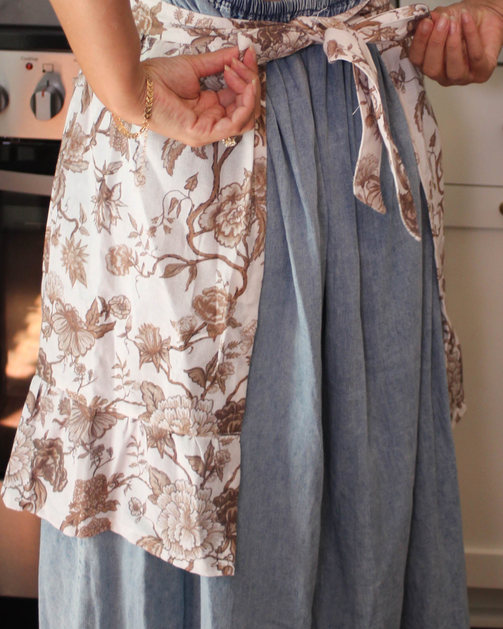 Hand-drawn floral apron with gathered waist and back ties, sustainable cotton kitchen accessory and perfect apron dress.