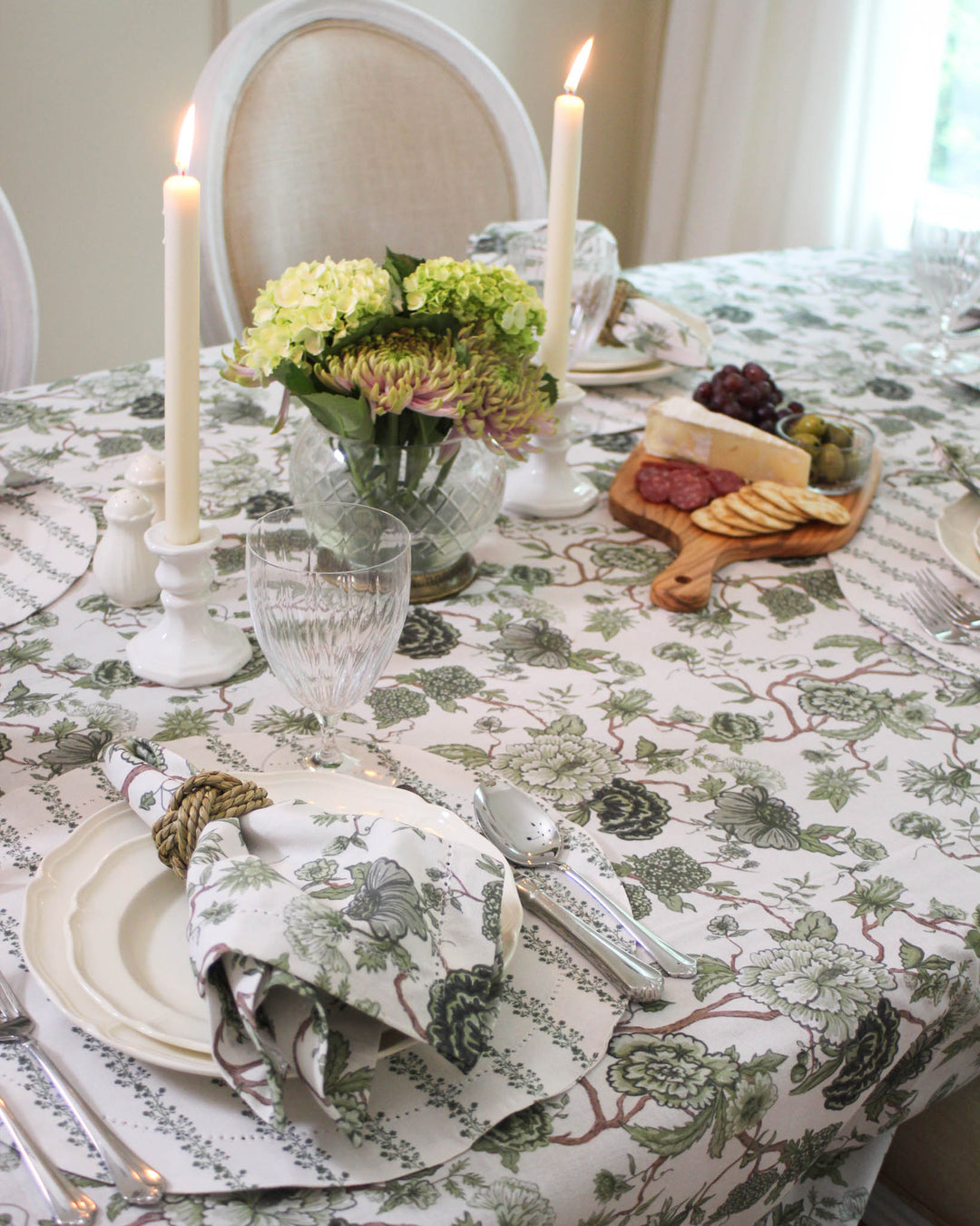 Elegant Rectangle Tablecloth with a sophisticated French Country influence. This Green Tablecloth Rectangle comes in 66x104 or 66x120 inches, fitting large tables for Easter Table Decor. A versatile Linen Tablecloth alternative that elevates any Mother's Day Brunch. The green flowers are hand-drawn for an artisanal touch. Pair this Floral Tablecloth with pearl napkin rings to create a seamless, high-end look for your Grand Millennial Decor tablescape.