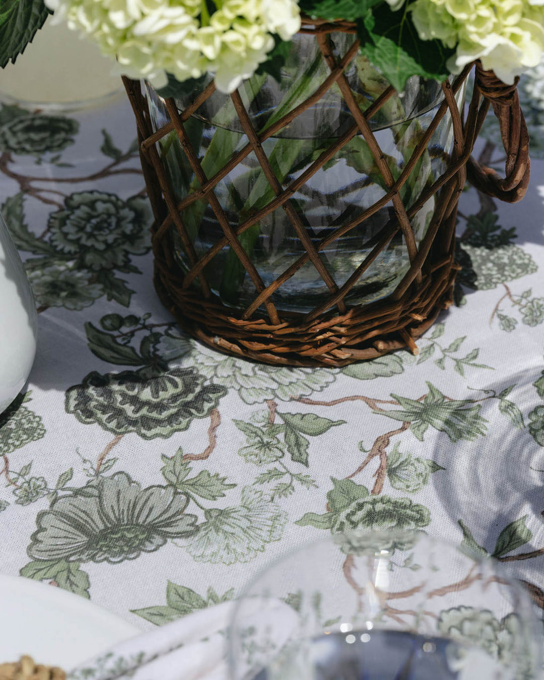 Green floral cotton tablecloth with matching napkins, styled for a summer tablescape and effortless seasonal hosting