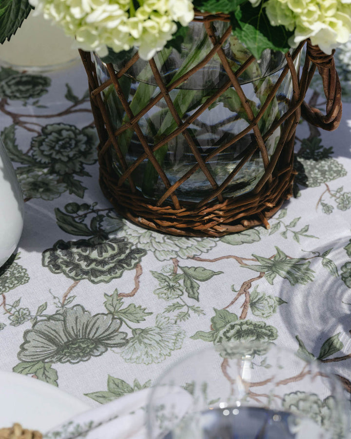 Green floral cotton tablecloth with matching napkins, styled for a summer tablescape and effortless seasonal hosting