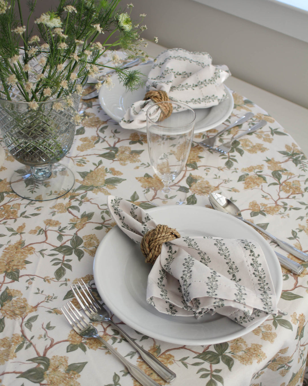 Green floral stripe cotton napkins styled on a spring  table with fresh florals and elegant place settings.