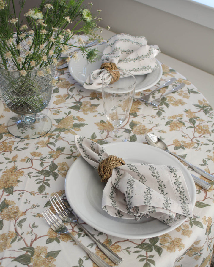 Green floral stripe cotton napkins styled on a spring  table with fresh florals and elegant place settings.