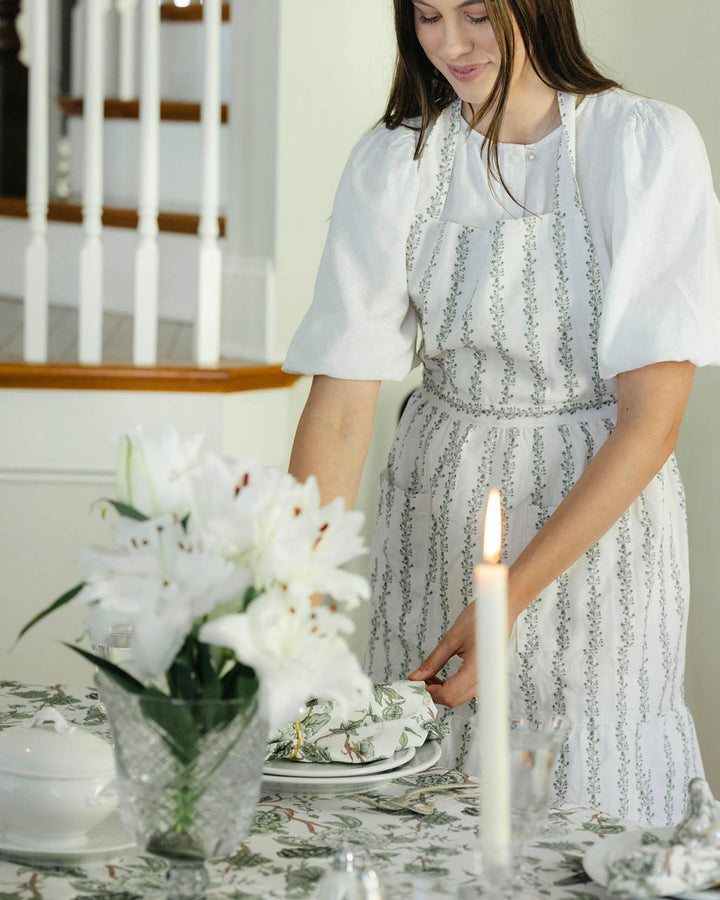 Women’s green floral stripe apron with soft ruffle detail, designed for cooking, baking, and thoughtful gifting