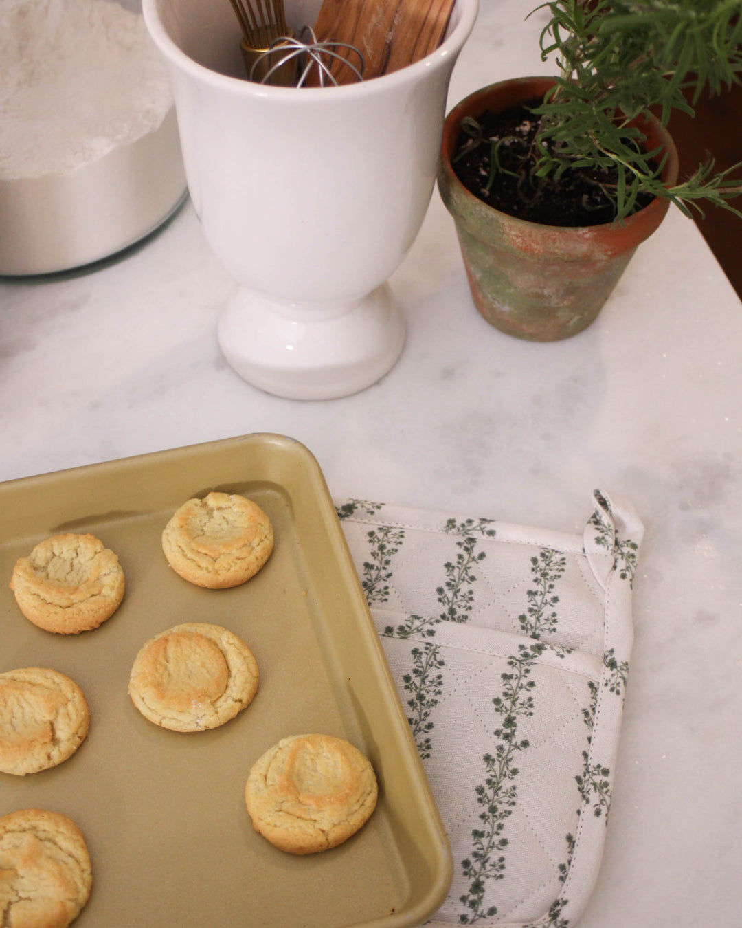 High-quality green floral stripe quilted cotton potholder set of 2, designed for the stylish country kitchen. These quilted hot pads are crafted from premium cotton with recycled cotton insulation to handle hot pans and trays safely. Each 8 inch woven potholder includes a loop for hanging storage. Ideal for grand millennial decor, they serve as the perfect floral hot pads or quilted trivets. Give the best gift for mom or a gift for her that combines beauty with utility for all baking.