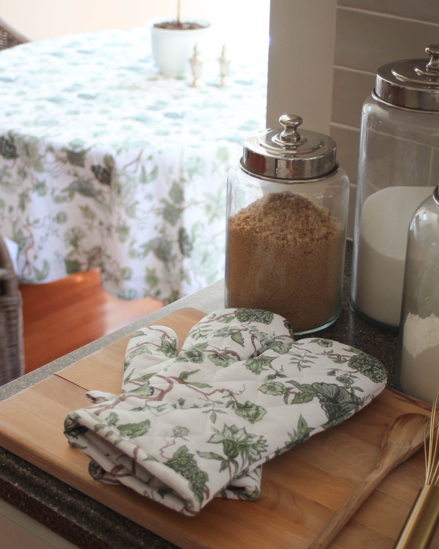 Green floral oven mitts for fall and winter hosting with matching tablecloth