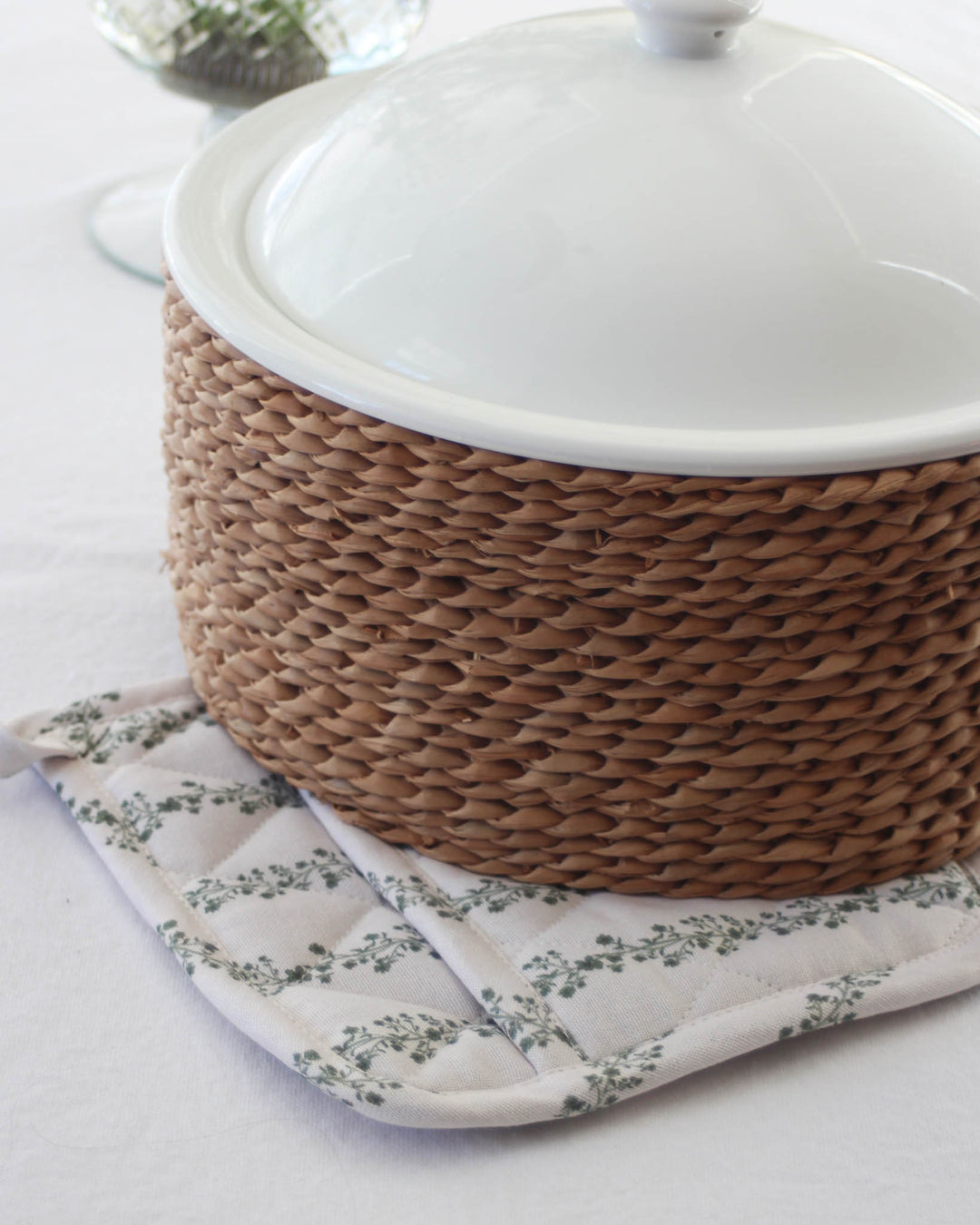 Heat-resistant cotton pot holders in floral stripe design, perfect for sourdough baking and serving dishes.