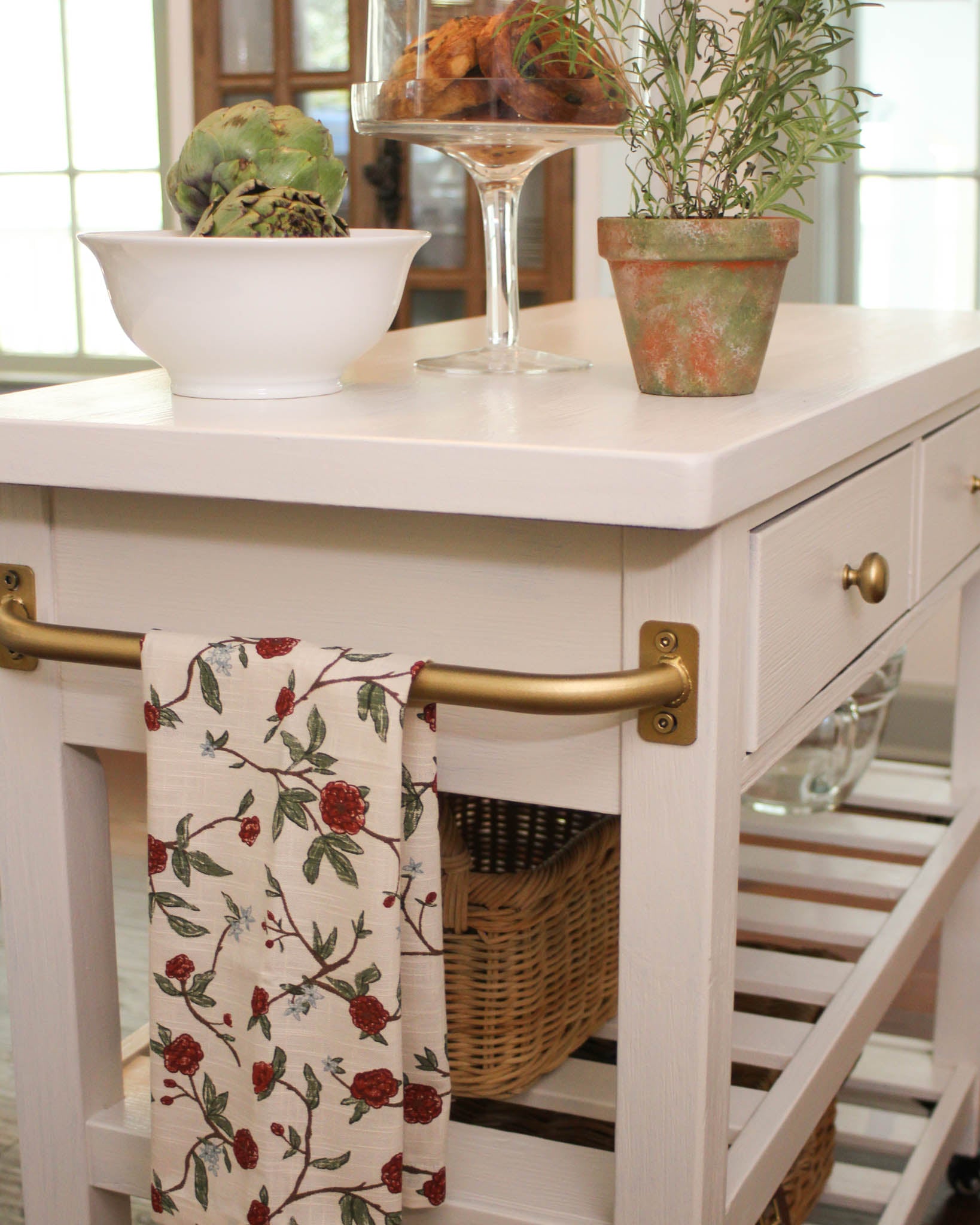 Hand-painted red floral tea towel in soft organic cotton. Hanging loop for display. Thoughtful Christmas gift for cooks who love festive kitchen style.