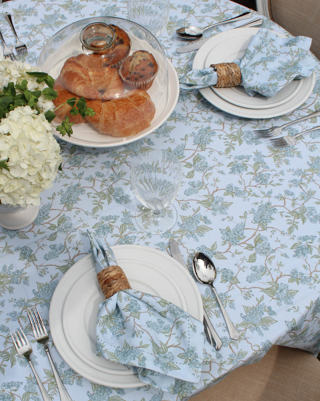 Elegant floral wedding tablecloth in blue and green featuring a chinoiserie botanical vine print. Made from 100% cotton, this rectangle tablecloth is ideal for Easter brunch, Mother’s Day hosting, or rehearsal dinner tables. Designed in Charleston and ethically produced in India with non-toxic dyes, it suits French country, English garden, farmhouse, and grand millennial decor styles.