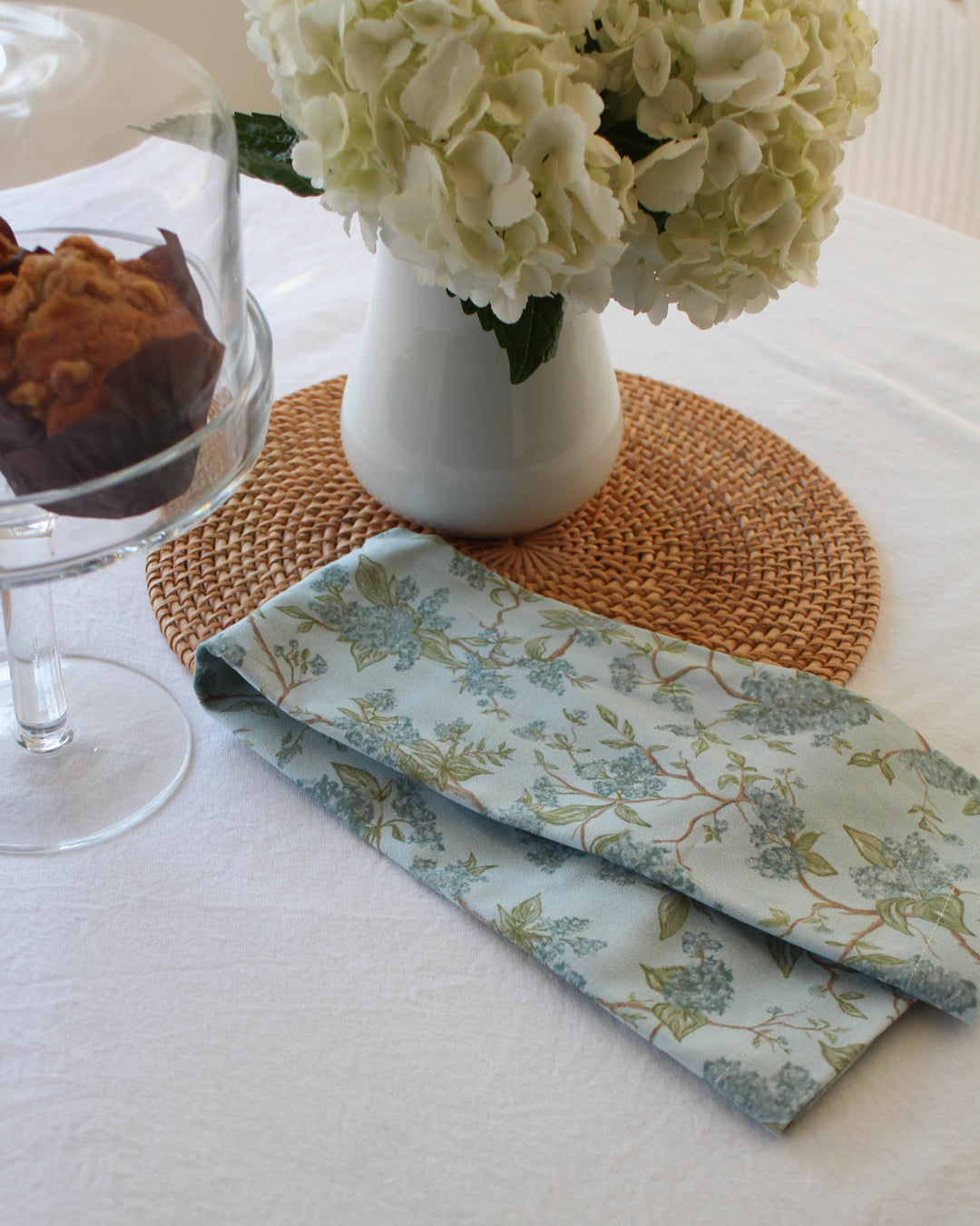 Hyacinth blue floral tea towel in 100% cotton with hanging loop, styled in a bright, coastal-inspired kitchen.