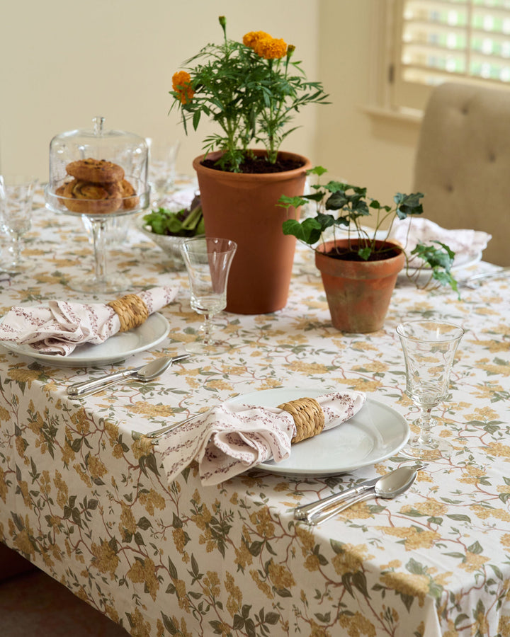Yellow marigold floral cotton tablecloth featuring a hand-drawn pattern, perfect for fall dining, Thanksgiving tables, autumn hosting, and timeless seasonal table settings.