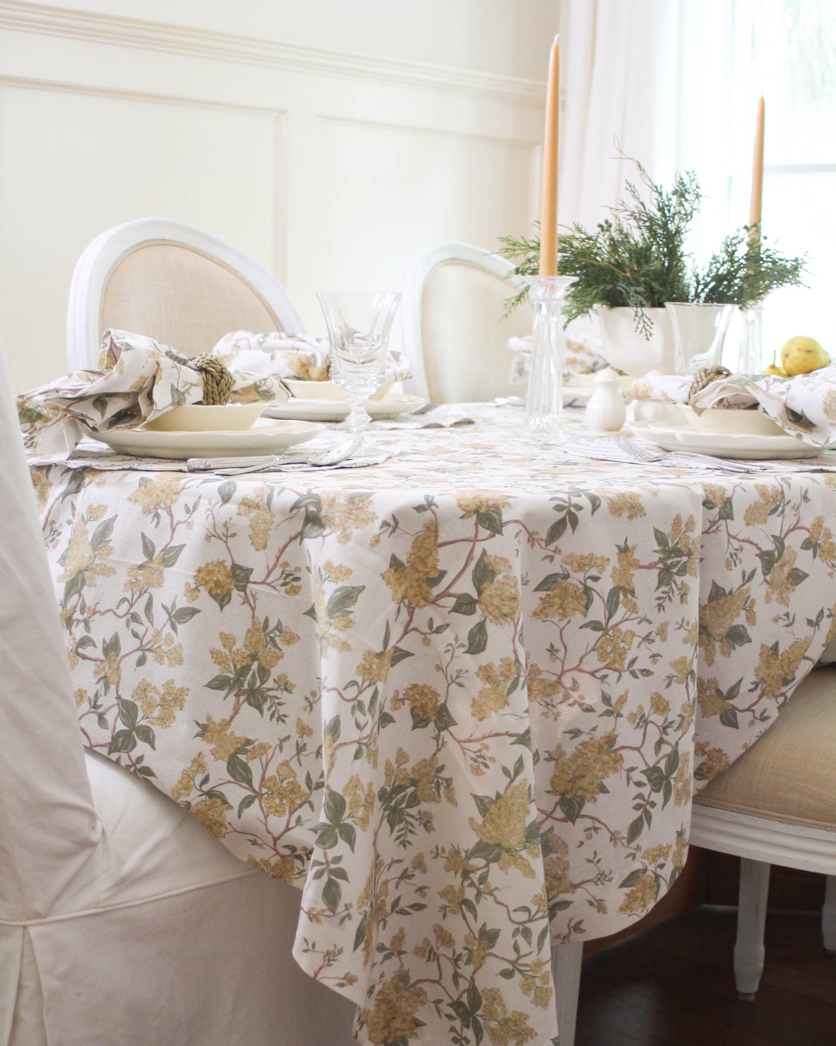 Hyacinth Marigold organic cotton tablecloth with hand-drawn floral design styled for a cozy fall dinner.