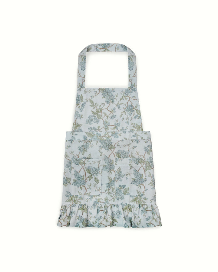 Blue floral kids apron made from organic cotton with adjustable straps, perfect for baking, crafts, and spring kitchen activities.