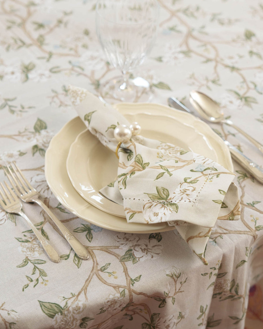 Spring hosting table styled with neutral floral camellia cotton napkins.
