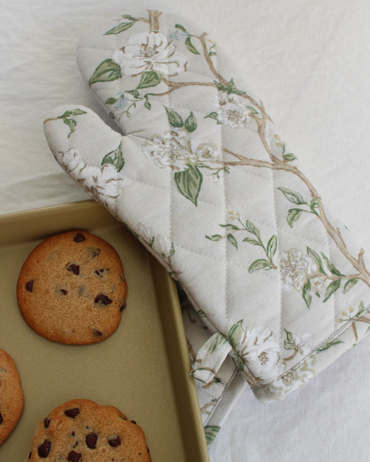Neutral floral cotton oven mitt designed as an elevated kitchen gift.