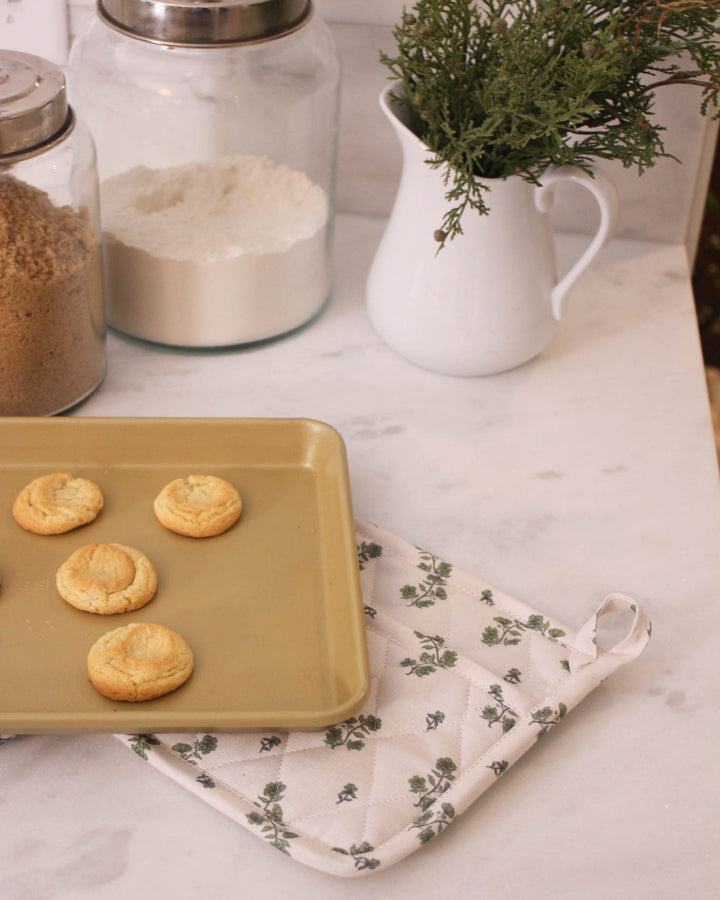 These green floral bouquet print potholders are the best gift for mom or a thoughtful grandma gift this spring. This set of 2 pot holders features a diamond stitching quilted design with recycled insulation for high heat resistance. Each 8 inch square woven potholder has a loop for hanging in a country kitchen. Use these floral hot pads as quilted trivets for Mother's Day brunch or Easter baking. The grand millennial decor style pairs beautifully with matching kitchen gift sets.