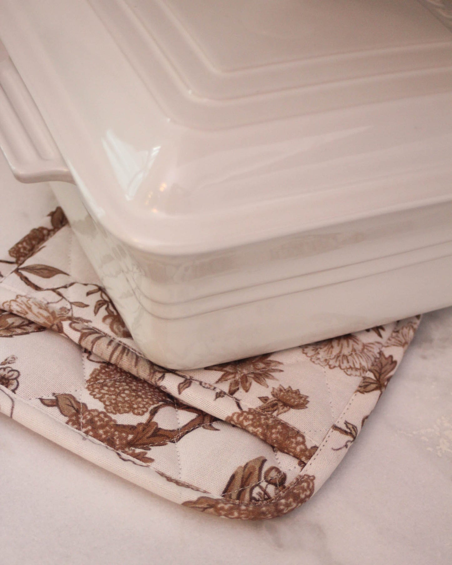 Hand-drawn floral pot holders in organic cotton. Quilted with heat-resistant lining, set of 2. Perfect for holiday baking & hostess gifts. Made in India.