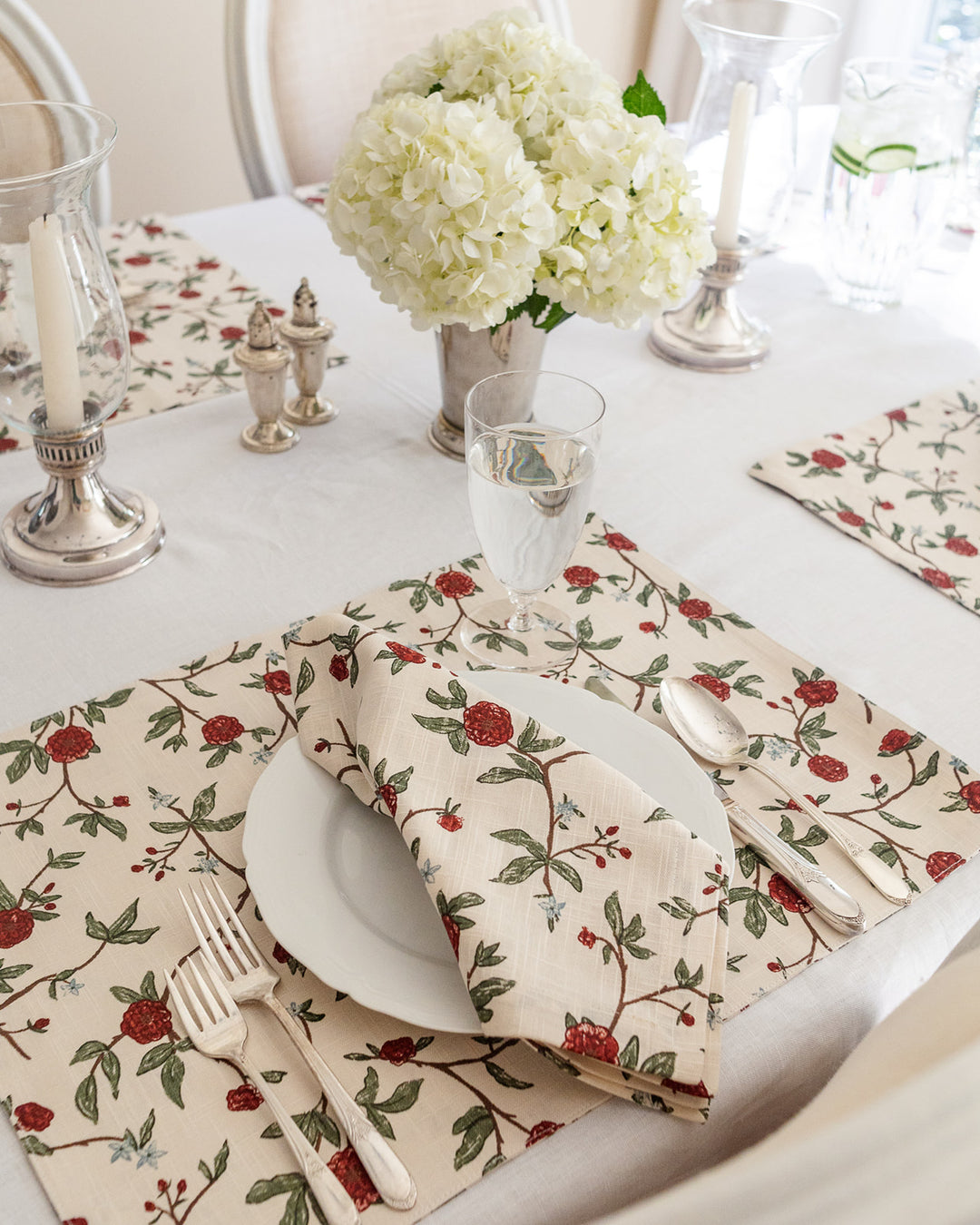 Elevate your table setting with these grand millennial red and green floral placemats. The intricate botanical design is both vintage-inspired and modern, making them perfect for a stylish spring brunch. These 14.5 inch by 20 inch cotton placemats offer a high-quality feel for your daily meals or special events. As reusable and washable placemats, they are a practical choice for busy homes. Pair these rectangle placemats with white plates to make the red floral print pop.