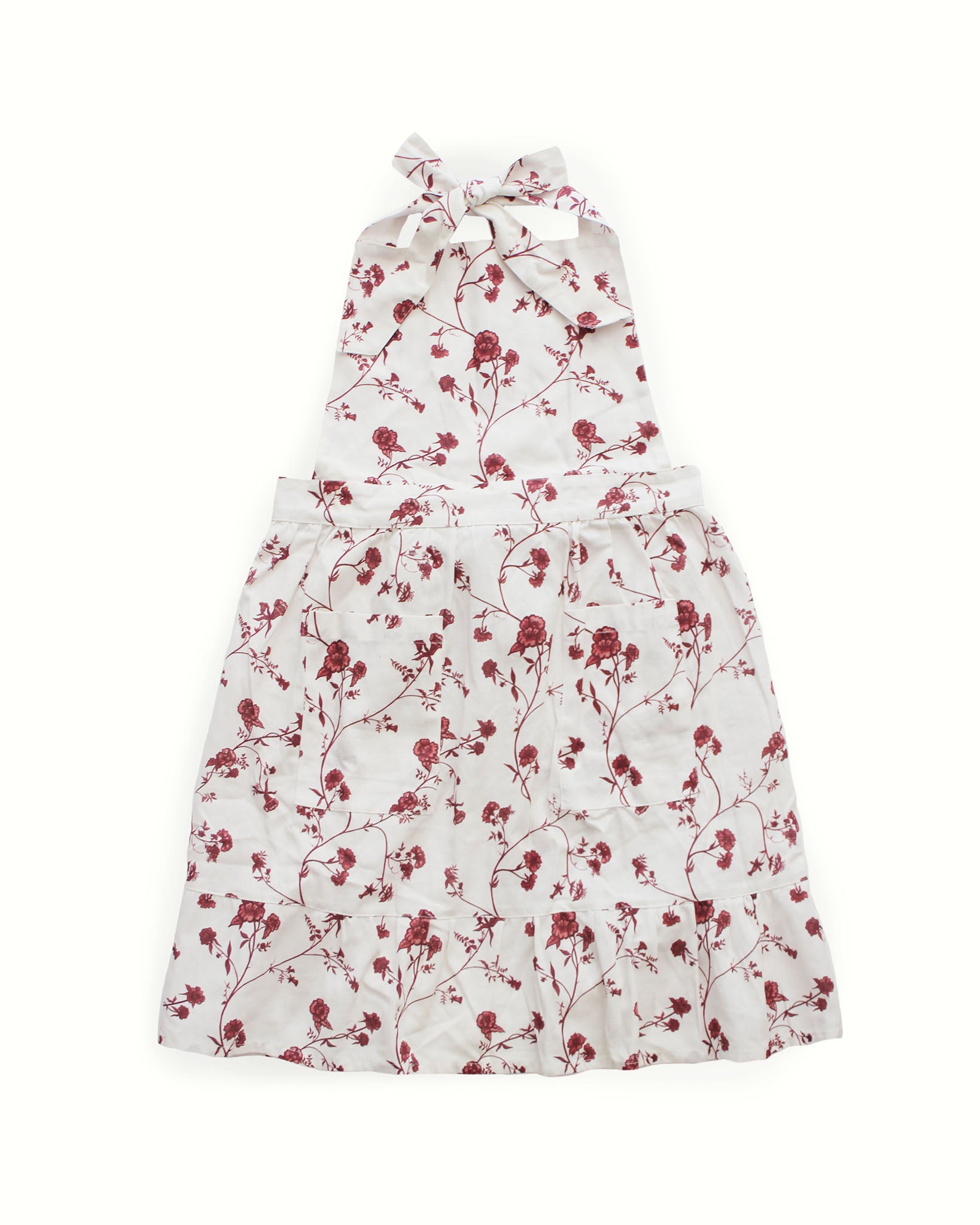 Sustainable organic cotton apron with floral print, perfect for festive gatherings and gifting.