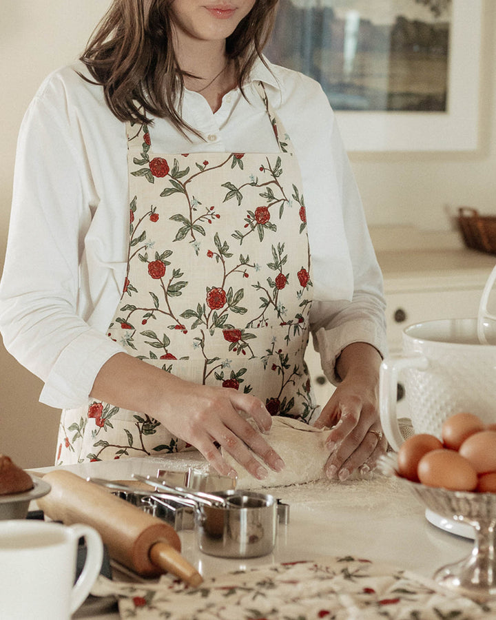Celebrate spring with this exquisite red and green floral smock apron dress featuring a ruffle hem. Made from premium 100% cotton, it includes two pockets and adjustable ties, perfect for a ruffle cooking apron or gardening apron. This baking apron for women is an ideal Mother's Day gift for mom or a thoughtful Easter hostess gift. Its grand millennial decor style and vibrant floral print make it a staple for spring summer entertaining and making special holiday memories.